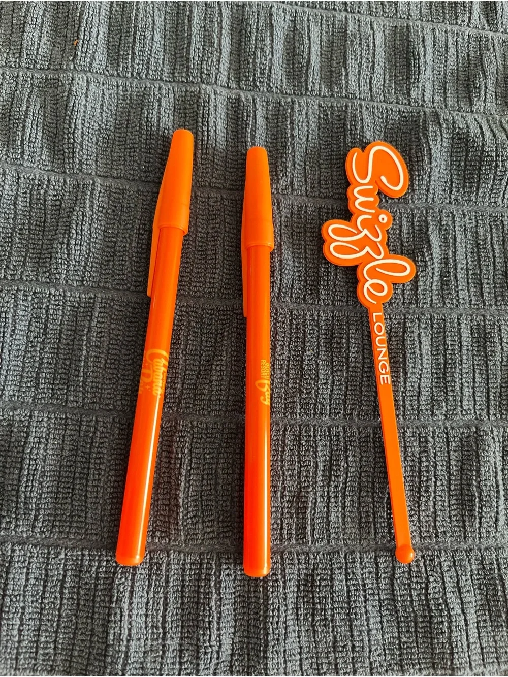 One Orange Drink Swizzle stick drink Stirrers and two Cabana Bay pens